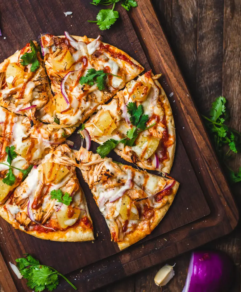 A delicious Italian pizza cooking in a traditional wood-fired oven with intense flames.